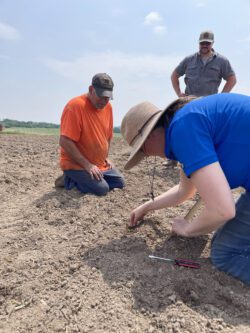 Keith and Albert Lea Seed team checking planting depth after first pass