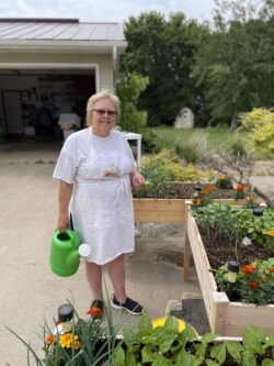 Theresa Speltz tending her raised gardens